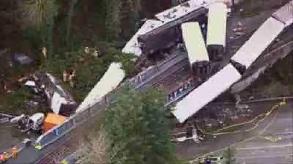 Several Killed As Train Derails, Dangles Over Highway